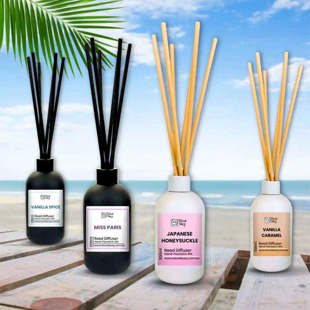 Reed diffuser bottles with fragrance sticks in black and white containers.