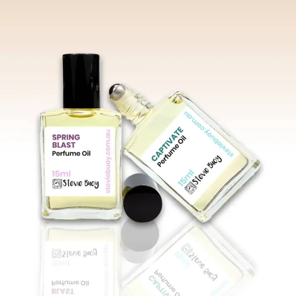 Two bottles of perfume oil with labels showing ’Spring Blast’ and ’Captivate’ fragrances.